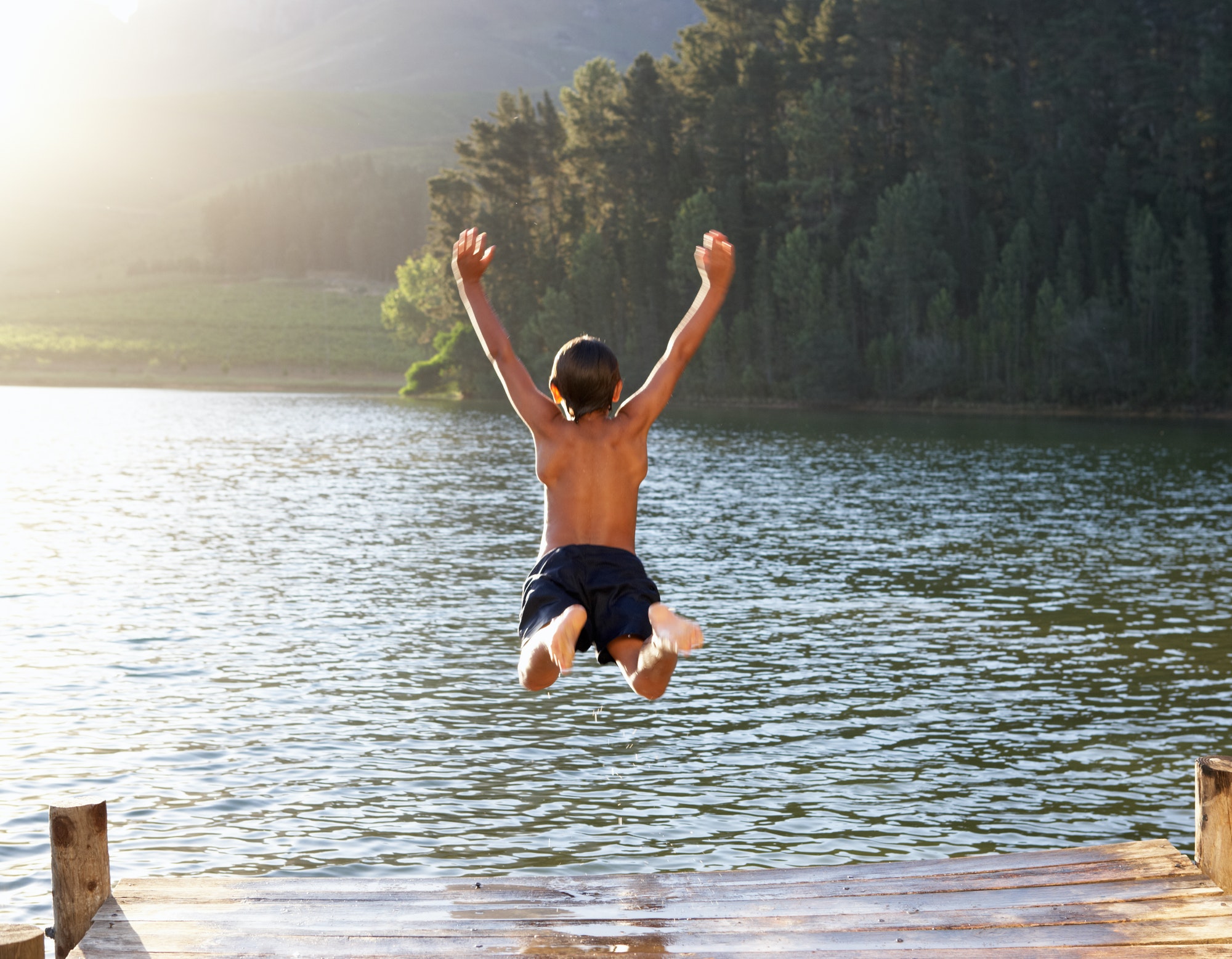 young-boy-jumping-into-lake.jpg